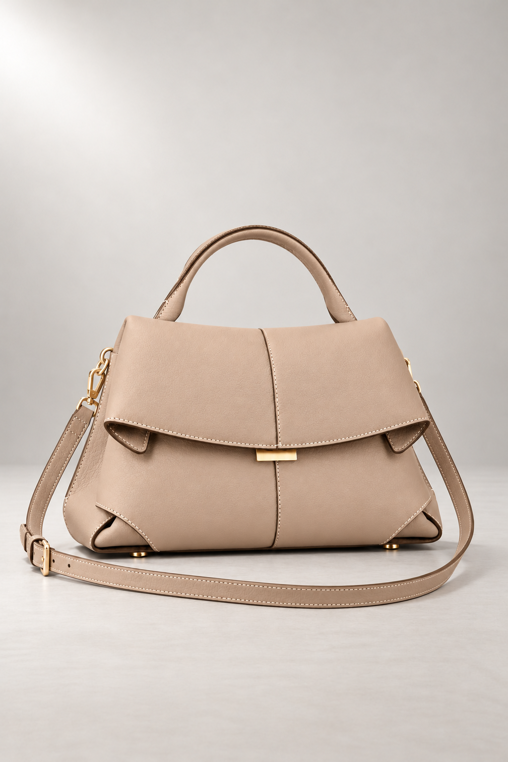 Matera Sculpted Handbag — Foldover Flap & Top Handle — Beige studio view